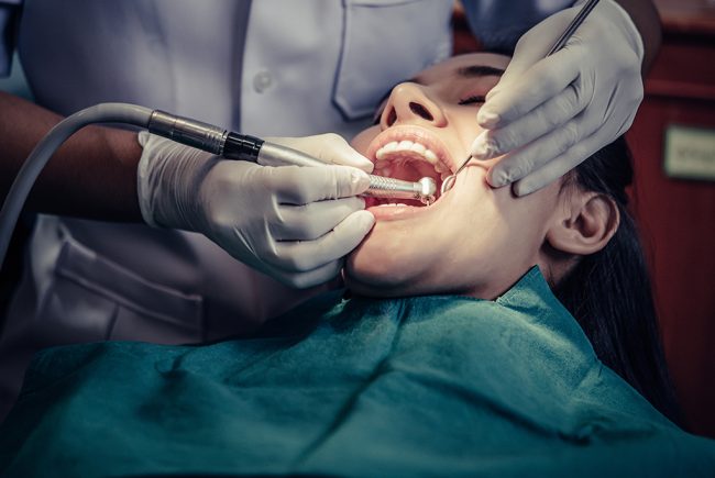 Woman in a uniform. Doctor working at the clinic. Dentist holds a tools in her hands